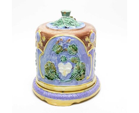 A Majolica ceramic cheese dome and stand, with stylised flower and leaf motif decoration, 31cms high.