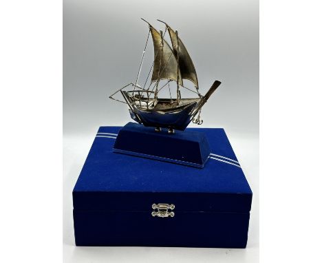 A 925 silver model of a sailing ship in presentation box. 23cm x 18cm. On stand. 