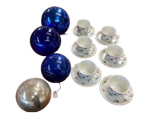 A Villeroy and Boch six person ceramic tea service, together with four large blown glass balls. Small chip to one cup. 
