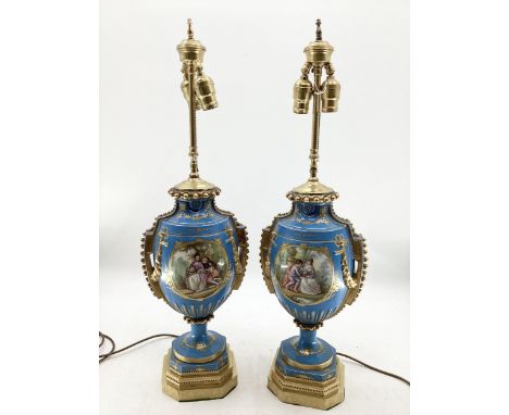A pair of Continental Meissen Style lamps, on stepped gilded base, the blue body with central oval panels decorated flowers a