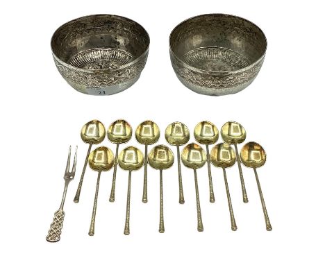 A pair of South Asian style white metal bowls with chased decoration together with a set of white metal coffee spoons with gi