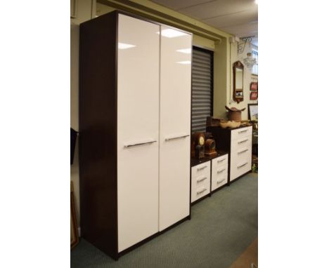 Modern four piece bedroom suite in cream and brown finish comprising: large wardrobe enclosing shelf over hanging space, four