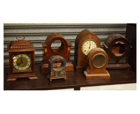 Six assorted early to mid 20th Century mantel clocks to include; a carved walnut bracket clock with Smiths electric movement,
