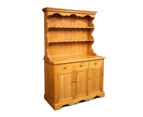 Stained pine high dresser having a two shelf rack with pot hooks and moulded cornice between shaped sides and planked back, t