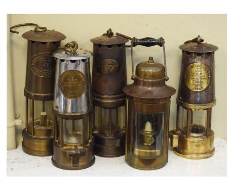 Five assorted miners and other safety lamps comprising: two examples by the Protector Lamp Lighting Co Ltd Eccles, The Cambri