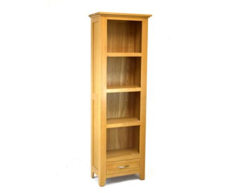 Modern light oak open bookcase of four shelves with base drawer   Condition: 