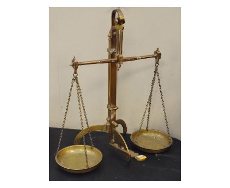 Set of late 19th/early 20th Century brass alloy beam scales to weigh 1lb, the stem rising and lowering on central pedestal be