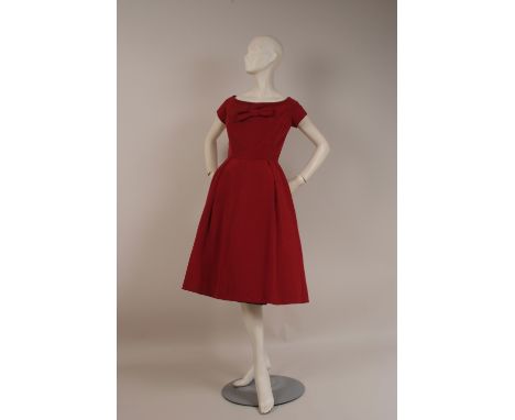 A 1950'S 'CHRISTIAN DIOR' COCKTAIL DRESS NUMBERED 9498 Beautifully feminine and elegant, this structured classical 1950's dre