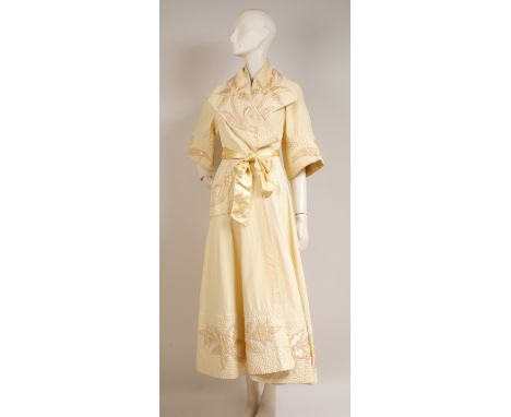 A 1950'S GOLD SATIN DRESSING GOWN Heavy gold satin, quilted and embroidered around the lapels, sleeves, pocket and hem. Tied 