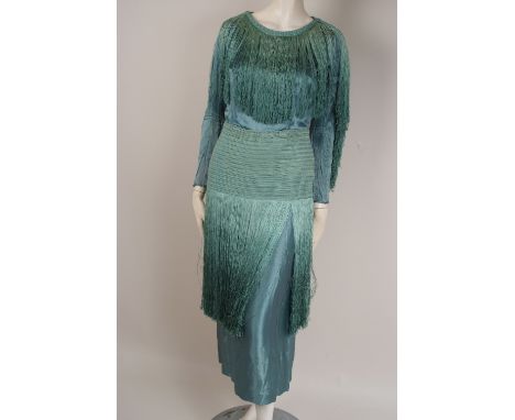 A 1930'S FRINGED EVENING DRESS A wonderful eau de nil heavy vintage satin dress.  The sleeves taper to a cuff with a line of 