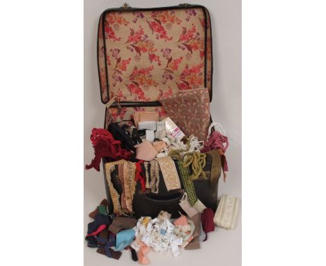 A COLLECTION OF VINTAGE HABERDASHERY  A suitcase of trims and braids. (qnty)