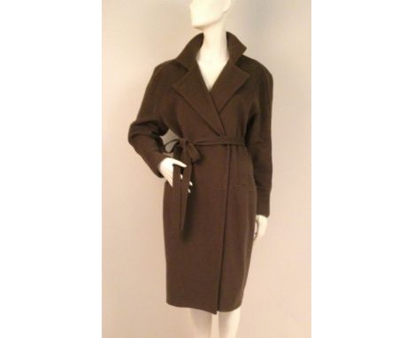 A 'GIANNI VERSACE' COAT Styled pure wool coat, moss green in colour, with pin-tucking across the shoulders, tapering down the