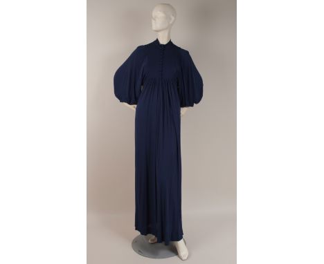 A 1970'S GINA FRATINI JERSEY DRESS Blue jersey silky fabric with blouson sleeves, faux buttons down the front, empire line. L