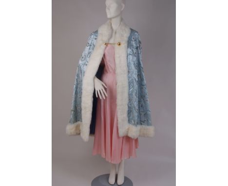 A FUR TRIMMED SILK AND BEADED CLOAK Light blue silk with silver thread embroidery and glass bead work.  Trimmed with white ra