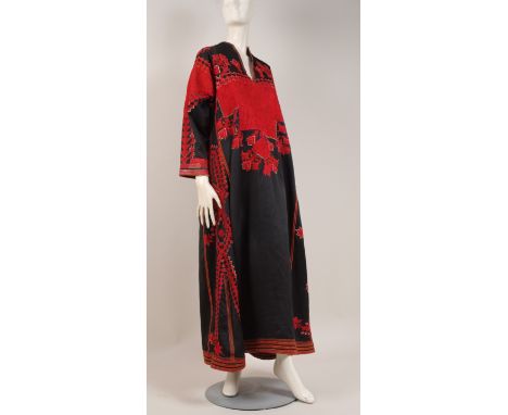 A TRADITIONAL LEVANT DRESS  Richly decorated with Palestinian cross stitch on a black heavy silk ground. Gussetted sleeves de