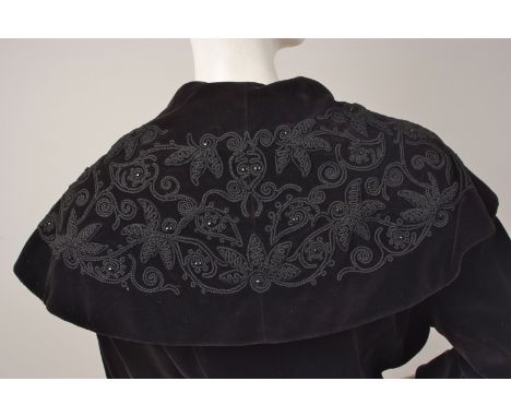 EDWARDIAN VELVET COAT Early 20th Century black velvet coat with wide embroidered collar, jewelled front button, lined, three 