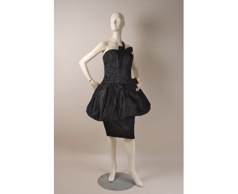 AN EARLY 1960'S 'CHRISTIAN DIOR' TULIP DRESS 'Numbered 26461'  Black satin dress with inner corset, fitted bodice, diaganol s