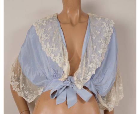 A SILK AND LACE BOUDOIR JACKET Pretty light blue silk bed jacket with white lace edging. (1)