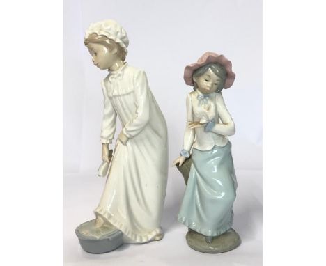 Two Lladro Nao figurines "Girl Takes a Footbath" and "Girl Holding Dove", tallest 28cm high / AN7 