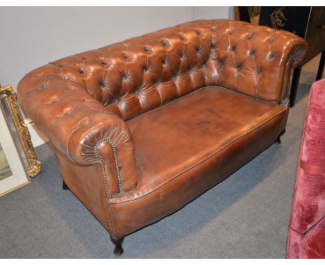 A leather upholstered two seat chesterfield sofa, first half 20th century, 154cm wide