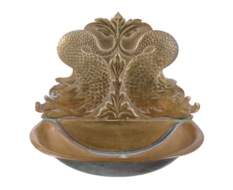 A Continental, possibly Low Countries repousse brass wall basin, late 19th century, the backplate with twin adorsed stylised 