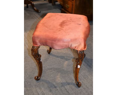 A Victorian carved walnut and upholstered stool in rococo revival style , 43cm high, the seat 42cm x 38cm