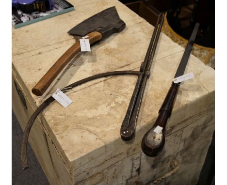 An iron axe with wood shaft; a large tool, possibly a screwdriver, and a pair of dividers