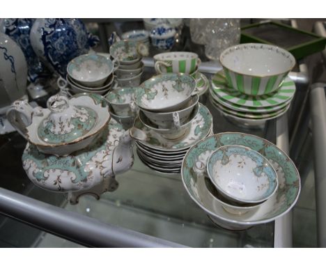 An English porcelain Rococo Revival part tea-service; the remnants of a Bloor Derby part tea-service and two fittings from an