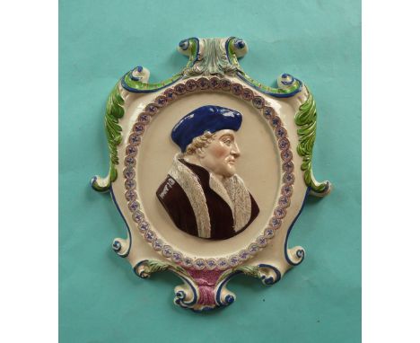 A Prattware plaque of scrolling outline moulded with a profile thought to be Desiderius Erasmus, well painted in coloured ena