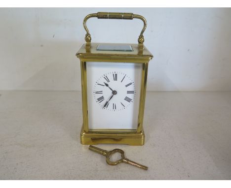 An early 20th century French striking two train carriage clock with key in good working order - Height 13cm