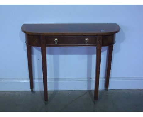 A good quality new walnut D end hall table, single drawer over square tapering supports terminating in castors - 91cm x 33cm 