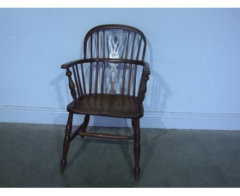 A 19th century ash and elm stick back armchair raised on turned supports joined by stretcher 