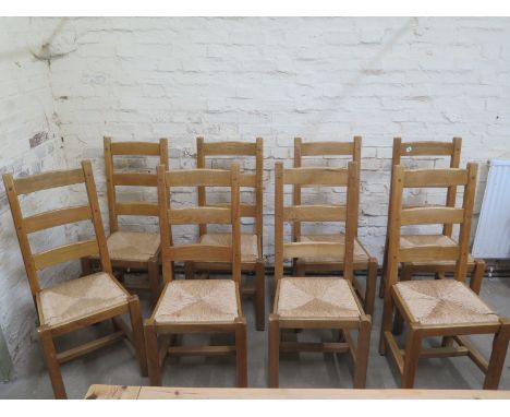 A set fo eight modern ladder back dining chairs with rush seats