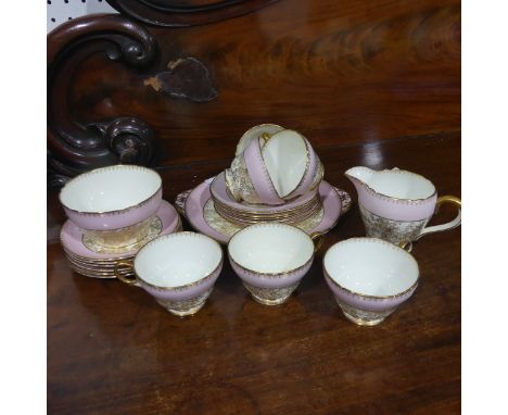 A Shelley pink ground and gilt pattern Tea Set, comprising six Tea Cups and Saucers, six Bread Plates, Cake Plate, Cream Jug 