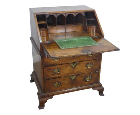 A small Georgian flame mahogany Bureau, sloped fall front enclosing gilt tooled writing skiver and fitted interior, above thr