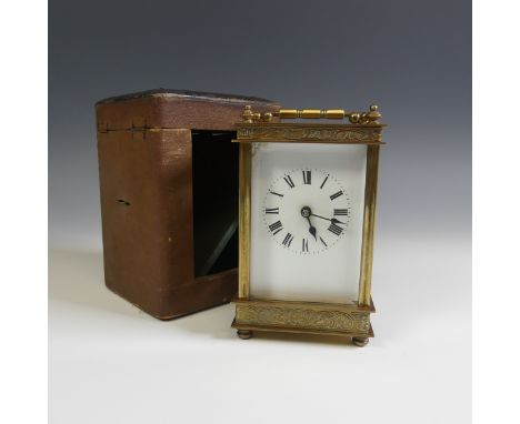 A 20th Century cased French 8 day gilt brass Carriage Clock, with engraved foliate edges, H 13 cm.