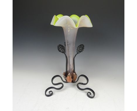 A 20thC glass and wrought iron Epergne, with tripod iron base and copper leaves enclosing trumpet shaped glass, H 36.5cm 