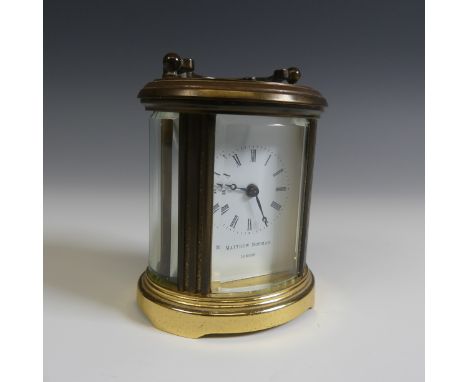 A miniature Matthew Norman oval five glass carriage Clock, H 8 cm.