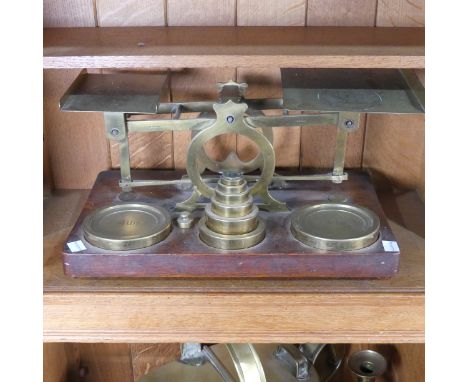 A set of S Mordan &amp; Co brass Postal Scales, on a wooden base with a set of brass weights, from half an ounce to four poun