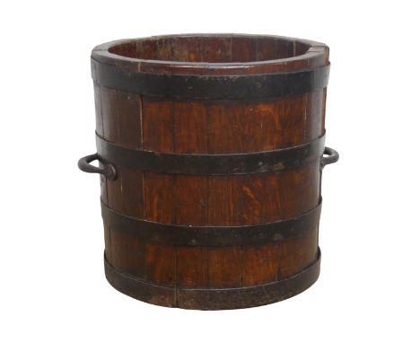 A Vintage metal bound oak circular coal bucket, with carrying handles to each side, W 34 cm x H 36 cm x D 34 cm. 