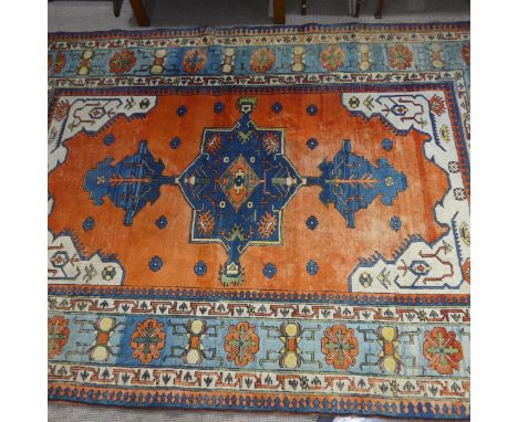 Tribal Rugs; a Turkish hand knotted 100% wool rug, the orange ground woven with bold geometric patterns in dark blue, light b
