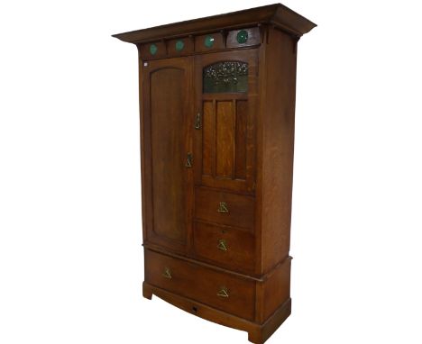 A Shapland and Petter of Barnstaple, Arts and Crafts oak Wardrobe, circa 1900, the projecting cornice above a frieze of four 