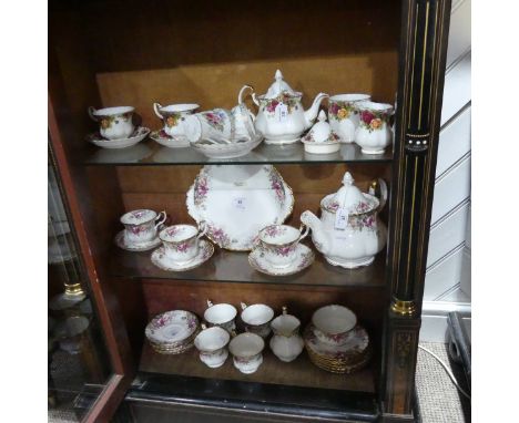 A Royal Albert 'Autumn Roses' Tea Service, comprising seven Tea Cups and eight Saucers, Teapot, seven Plates, Cake Plate, Sug