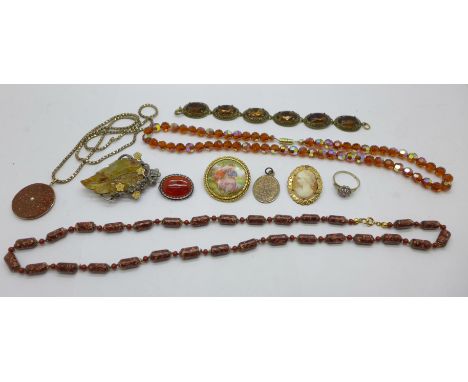 Costume jewellery including an Arts and Crafts brooch set with a carved jade leaf, not marked or signed, an agate set brooch,