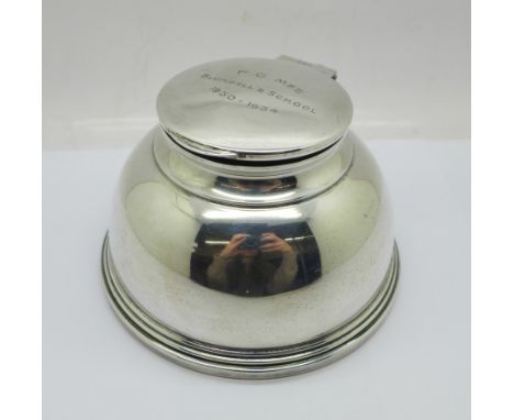 A silver inkwell, London 1931, top bears inscription, diameter of base 12cm, top dented 