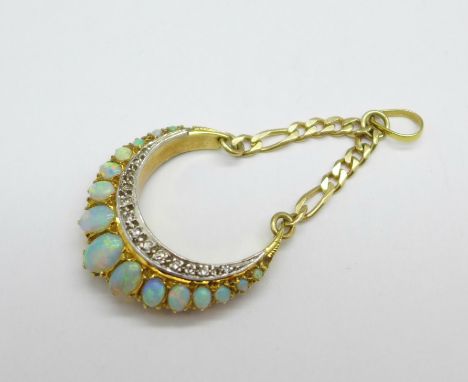 An 18ct gold, opal and diamond half moon shaped pendant, hallmarked London 1975, set with fifteen opals, the largest 5mm x 6m