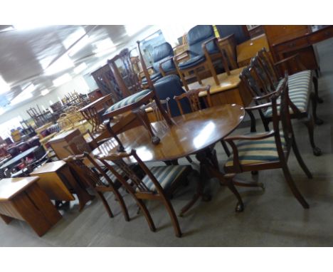 A Regency style mahogany pedestal dining table and seven Chippendale style dining chairs 