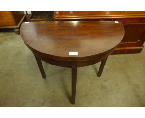 A mahogany demi lune card table 