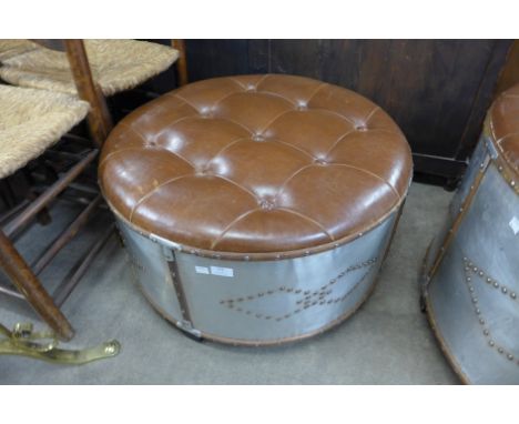 A brown leather and aluminium circular stool 