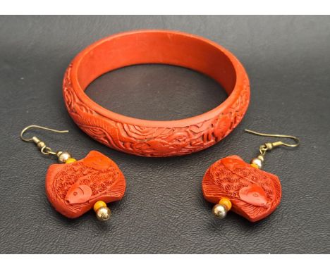 CHINESE RED CINNABAR LACQUER BANGLE AND PAIR OF EARRINGSthe bangle with carved dragon decoration and the earrings with intric